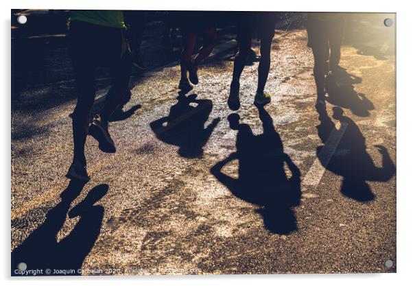 Muscled legs of a group of several runners training running on asphalt Acrylic by Joaquin Corbalan