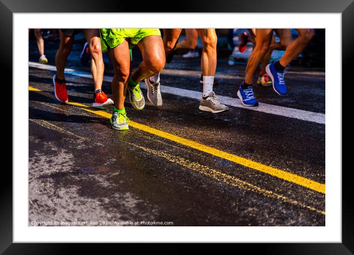 Muscled legs of a group of several runners training running on asphalt Framed Mounted Print by Joaquin Corbalan