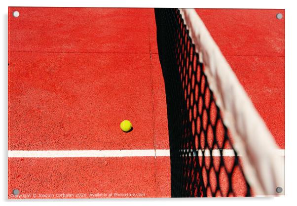 A tennis ball on the textured floor of a red court near the net after losing a match point. Acrylic by Joaquin Corbalan