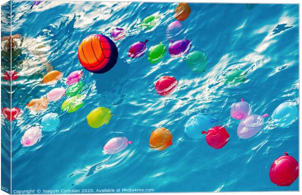 Group of many colorful plastic water balloons floating in the water of a pool to entertain their children on summer vacations. Canvas Print by Joaquin Corbalan