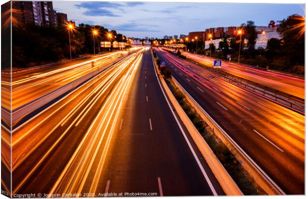 Trails of car lights on a large road at night. Canvas Print by Joaquin Corbalan