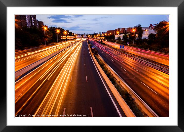 Trails of car lights on a large road at night. Framed Mounted Print by Joaquin Corbalan