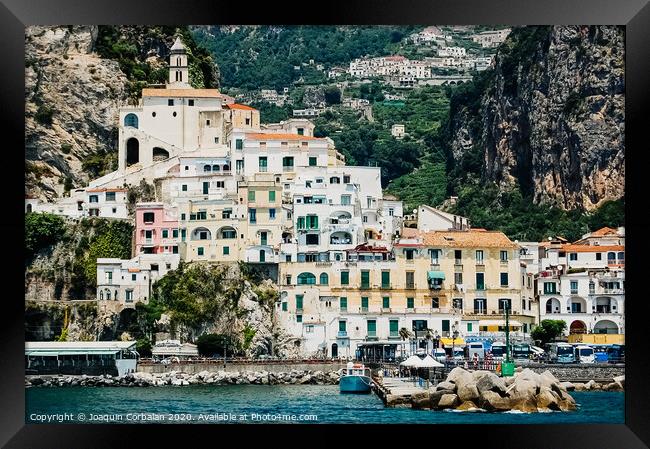 Sorrento, Italy - June 5, 2019: View from the sea of this picturesque Italian Mediterranean city, with old and colorful houses built on the side of a hill. Framed Print by Joaquin Corbalan