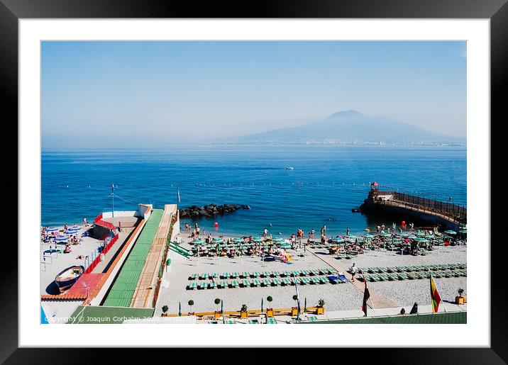  A beach with sunbathers in Sorrento, with background of unfocused view of Vesuvius volcano. Framed Mounted Print by Joaquin Corbalan