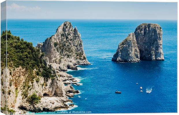 Natural rock arches and cliffs on the coast Sorrento and Capri, Italian islands with crystal clear waters where tourist boats crowd to photograph them in summer. Canvas Print by Joaquin Corbalan