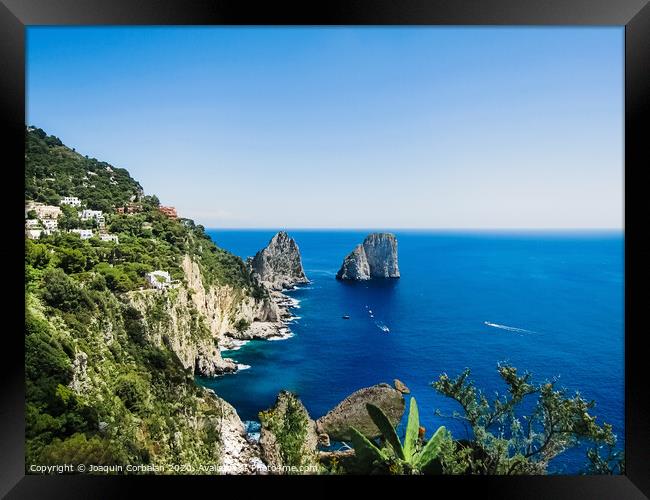 Natural rock arches and cliffs on the coast Sorrento and Capri, Italian islands with crystal clear waters where tourist boats crowd to photograph them in summer. Framed Print by Joaquin Corbalan