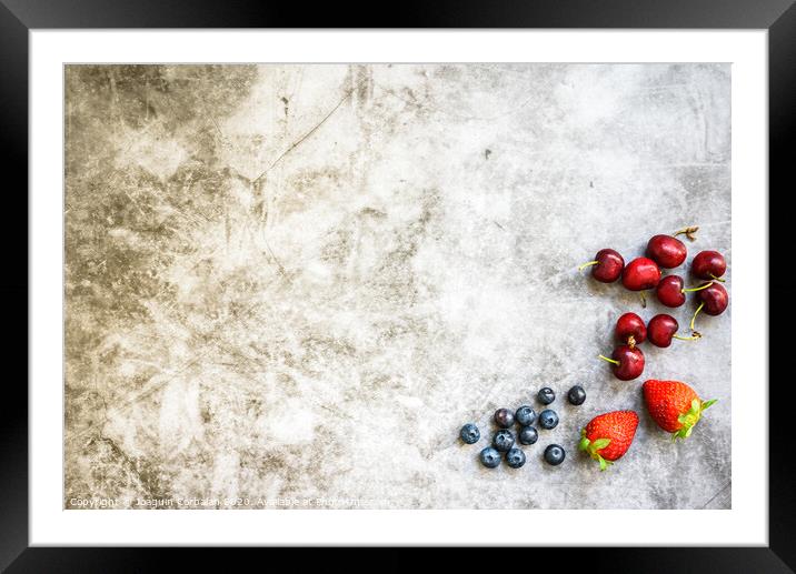 Clean background with a lot of negative space for healthy food, with red fruits on one side. Framed Mounted Print by Joaquin Corbalan