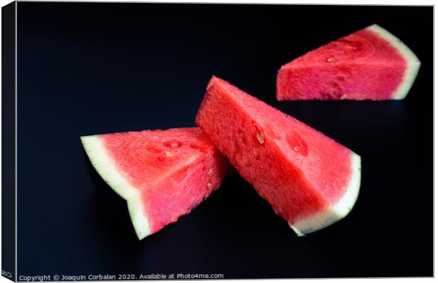 Three slices of watermelon stacked of intense color isolated on black background. Canvas Print by Joaquin Corbalan