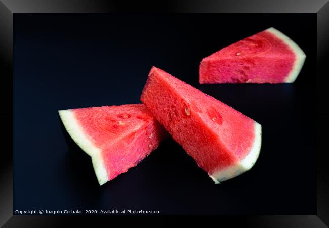 Three slices of watermelon stacked of intense color isolated on black background. Framed Print by Joaquin Corbalan