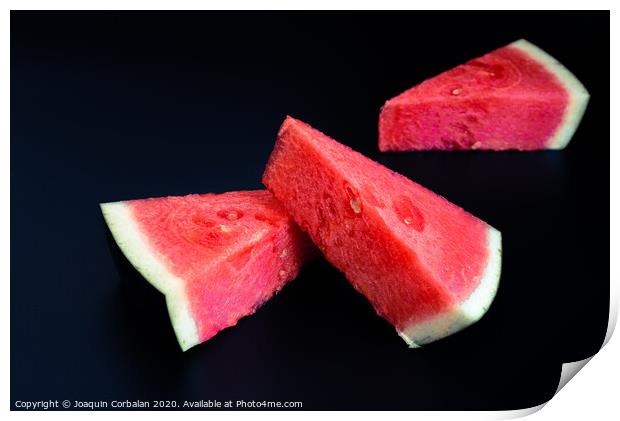 Three slices of watermelon stacked of intense color isolated on black background. Print by Joaquin Corbalan