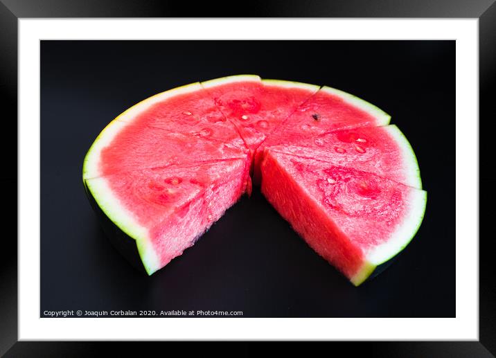 A large slice of watermelon divided into smaller pieces, flat, red, isolated on a black background, as a data chart. Framed Mounted Print by Joaquin Corbalan
