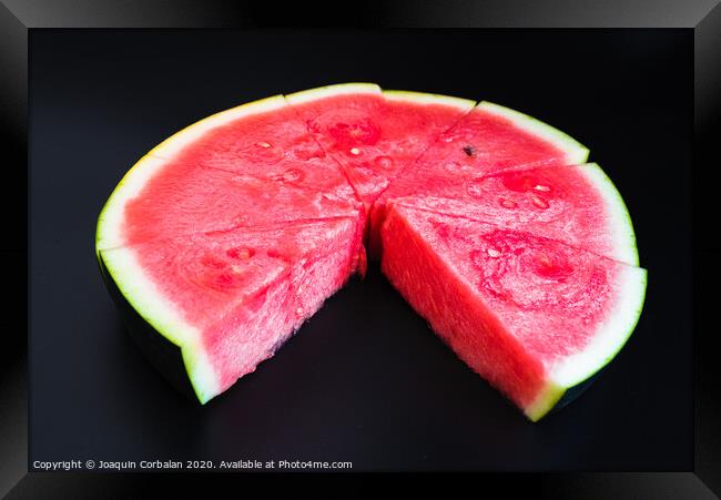 A large slice of watermelon divided into smaller pieces, flat, red, isolated on a black background, as a data chart. Framed Print by Joaquin Corbalan