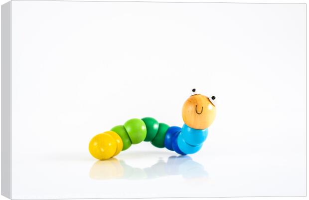 Toy caterpillar with smile, to illustrate concepts of infant intestinal health. Canvas Print by Joaquin Corbalan