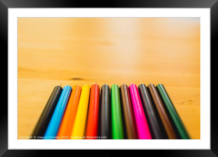 Colored pencils ordered to paint at school. Framed Mounted Print by Joaquin Corbalan
