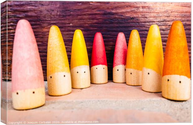Set of colored wooden conical fish toys for unstructured children's games. Canvas Print by Joaquin Corbalan