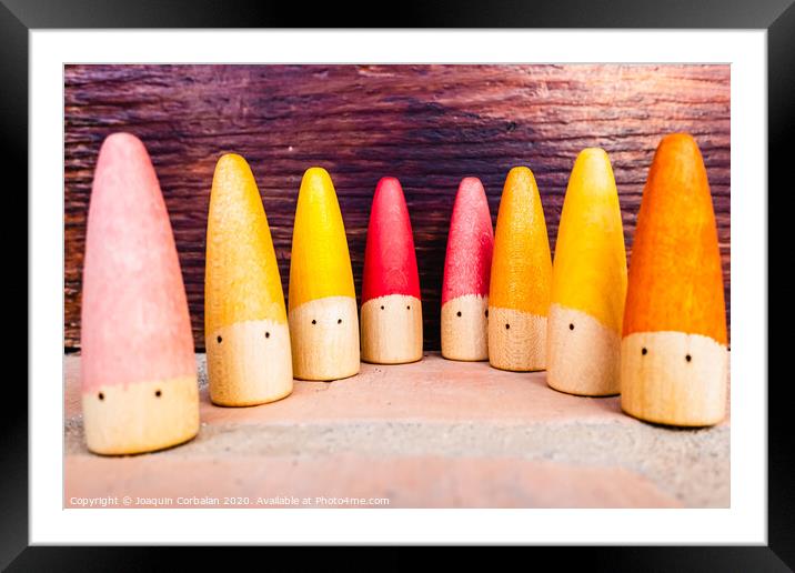 Set of colored wooden conical fish toys for unstructured children's games. Framed Mounted Print by Joaquin Corbalan