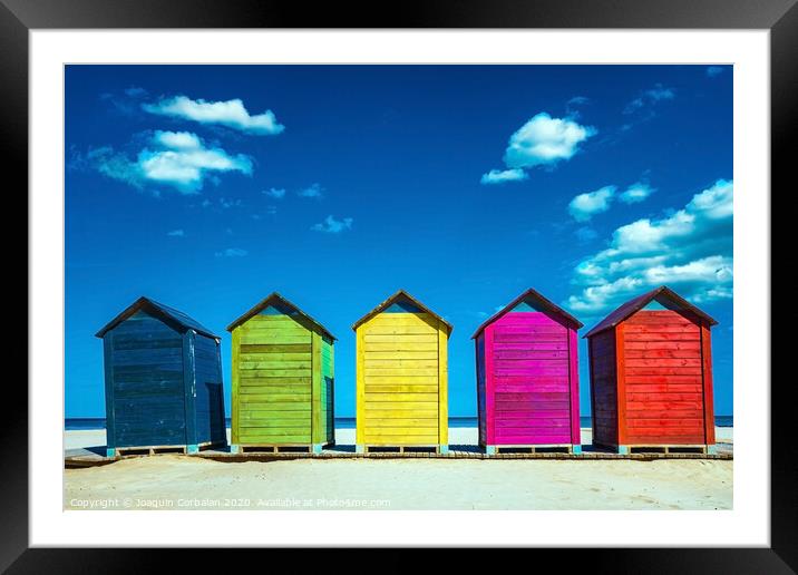 Colorful wooden changing huts on a beach, with nice background of clear blue sky on the coast. Framed Mounted Print by Joaquin Corbalan