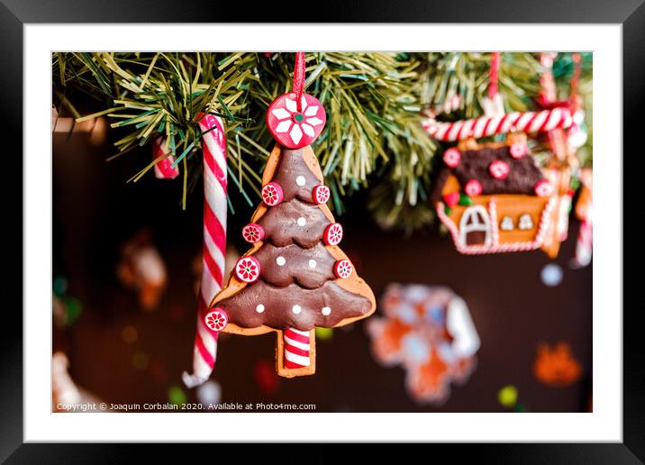 Dolls to decorate at Christmas hanging from the childlike tree. Framed Mounted Print by Joaquin Corbalan