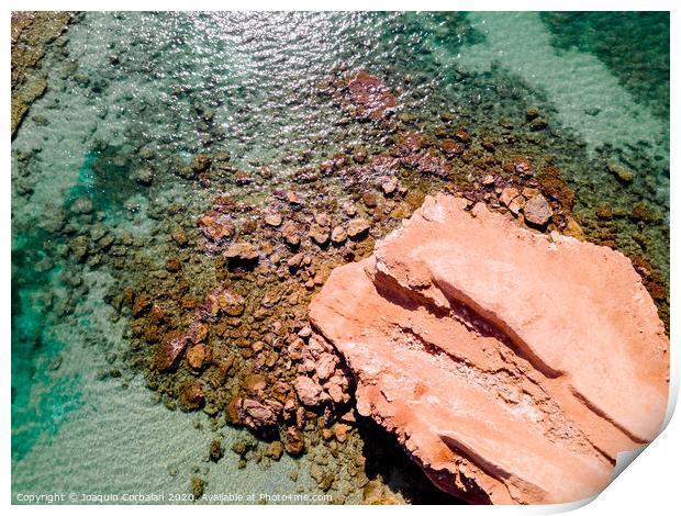 Aerial view of a natural rock jetty on the Mediterranean coast with transparent turquoise waters. Print by Joaquin Corbalan