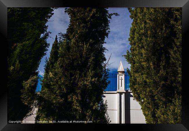 High white concrete walls with metal grating of a cemenery, seen through the cypress trees. Framed Print by Joaquin Corbalan