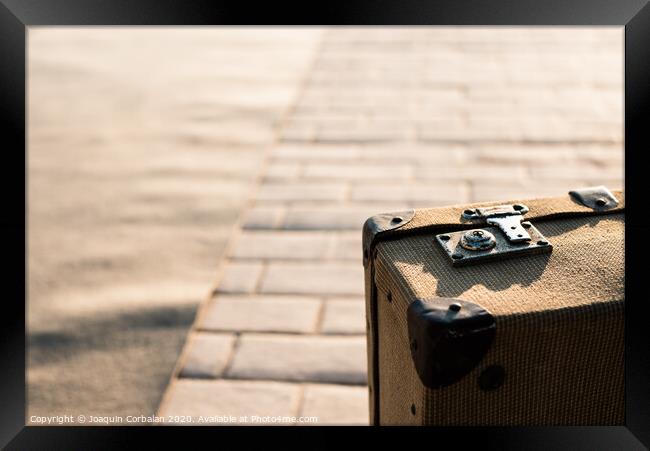 Close-up detail of an old vintage suitcase with blur background with copy space. Framed Print by Joaquin Corbalan