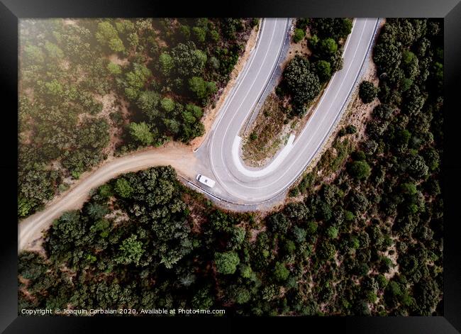Motorhome parked on the curve of a mountain road, seen from above, of some tourists on the road. Framed Print by Joaquin Corbalan