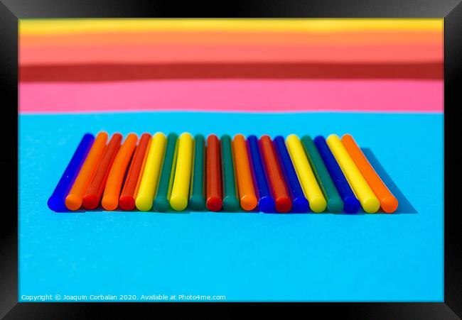 Colorful background of plastic bars, silicone glue, on a background of colored lines. Framed Print by Joaquin Corbalan