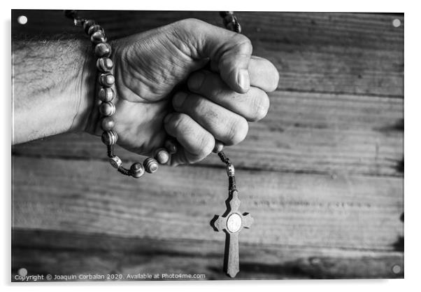 Hand of a religious person holds a Christian rosary during his prayers, unfocused background of woods in black and white. Acrylic by Joaquin Corbalan