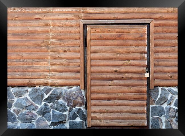 Wooden door to the utility room of a house standing on a stone foundation Framed Print by Sergii Petruk