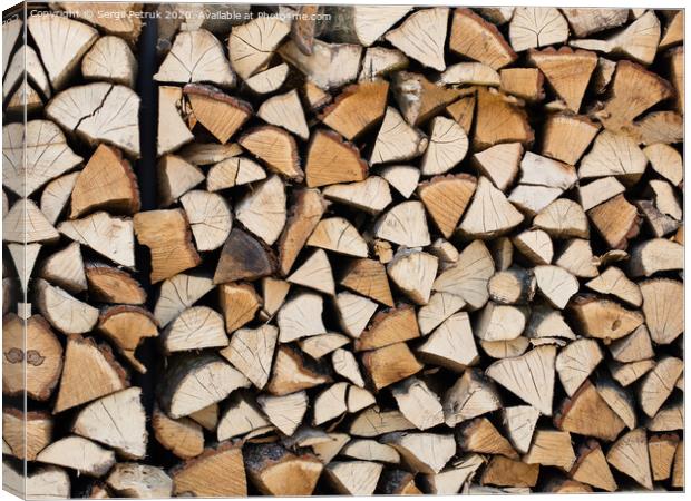 A stack of chopped firewood stacked on top of each other Canvas Print by Sergii Petruk