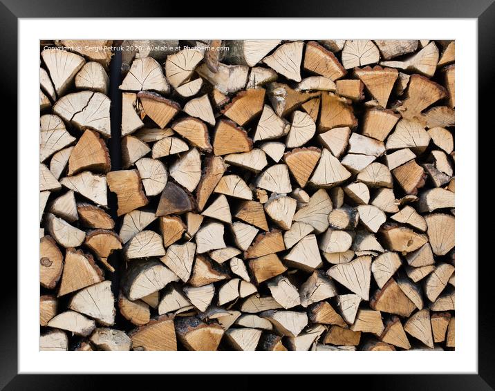 A stack of chopped firewood stacked on top of each other Framed Mounted Print by Sergii Petruk