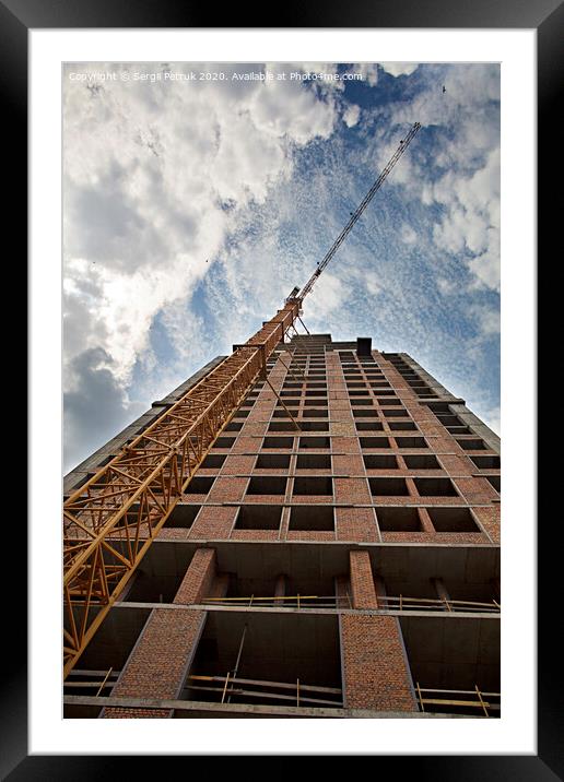 New house under construction with a tower crane against the blue sky and birds in the sky Framed Mounted Print by Sergii Petruk