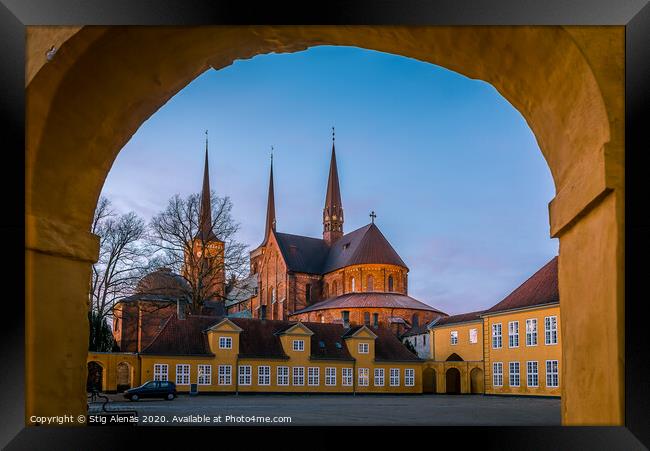 Roskilde cathedral in the soft evening light under the yellow portal of Roskilde Palace Framed Print by Stig Alenäs