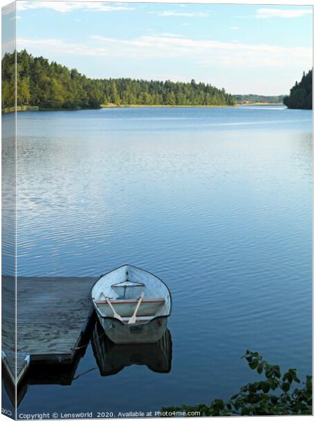 Calm lake with rowboat in Sweden Canvas Print by Lensw0rld 