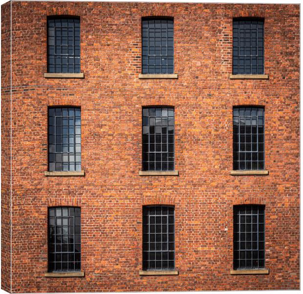 Windows in Albert dock warehouse in Liverpool , England. Canvas Print by George Robertson