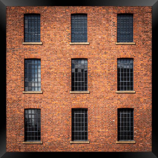 Windows in Albert dock warehouse in Liverpool , England. Framed Print by George Robertson