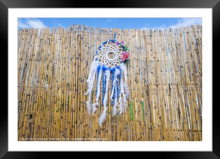 Vintage indigenous decoration hanging from a wall of old reeds, intense colors. Framed Mounted Print by Joaquin Corbalan