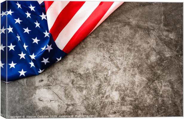 Striking colored American flag isolated in a corner on a stone gray background. Canvas Print by Joaquin Corbalan