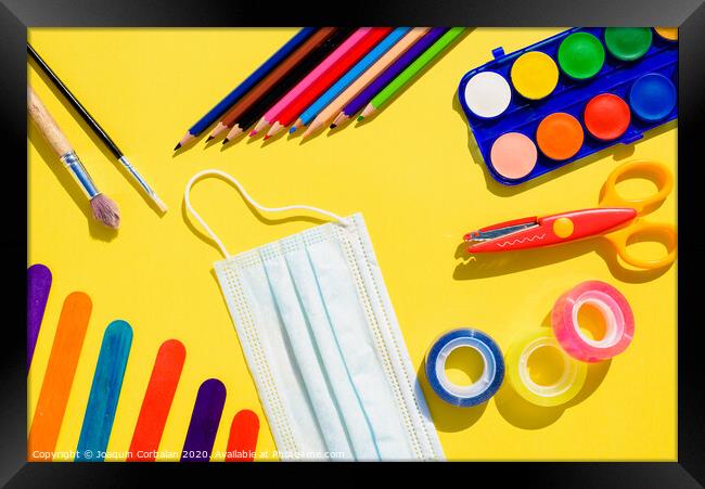 School supplies next to a face mask, flat lay background back to school. Framed Print by Joaquin Corbalan