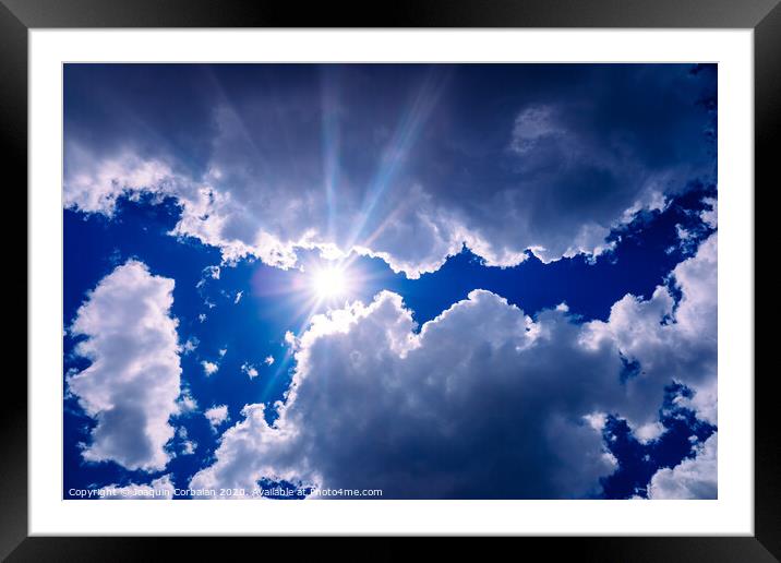 Uva and uvb rays of the sun pass through the atmosphere and the clouds to the skin of people. Framed Mounted Print by Joaquin Corbalan