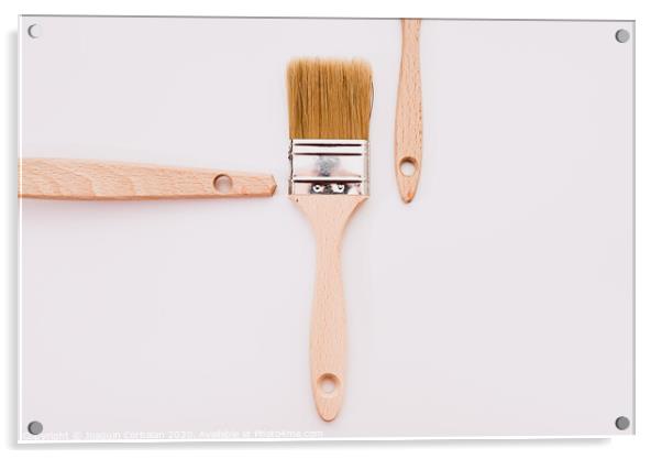 Simple background with new wooden paintbrushes isolated on white studio background. Acrylic by Joaquin Corbalan