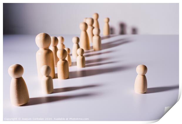 Social distance symbolized with wooden figures isolated from each other on white background. Print by Joaquin Corbalan