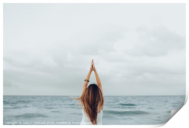 A woman relaxes in front of the sea with her hands up, unfocused background. Print by Joaquin Corbalan