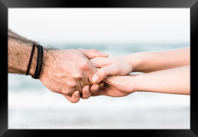 Two hands joined as a symbol of friendship with unfocused background. Framed Print by Joaquin Corbalan