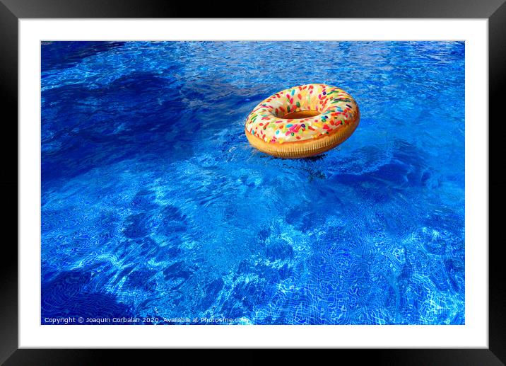 Detail with copy space of a round float in a pool with clean and refreshing waters, background with negative space for summer. Framed Mounted Print by Joaquin Corbalan