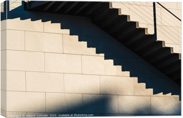 Minimalist wall with shadows from the upper steps of a modern stone staircase. Canvas Print by Joaquin Corbalan