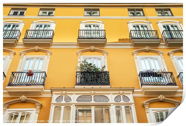 Bright facade of a typical old Mediterranean building painted in bright colors and warm tones. Print by Joaquin Corbalan