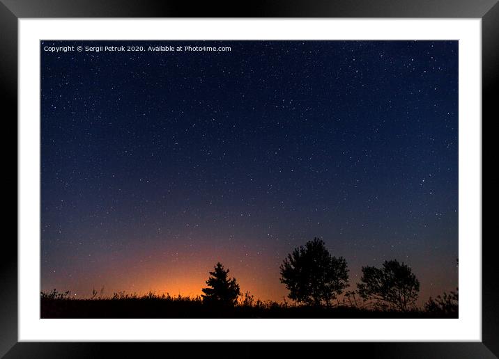 Silhouettes of three trees against the background of the night starry sky and the setting sun Framed Mounted Print by Sergii Petruk