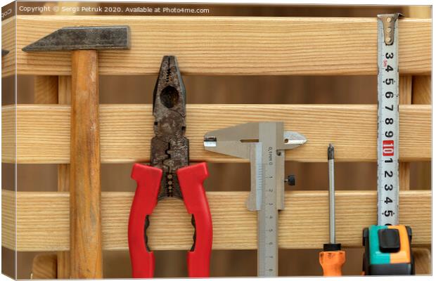 Old Construction tools on wooden slats close-up Canvas Print by Sergii Petruk