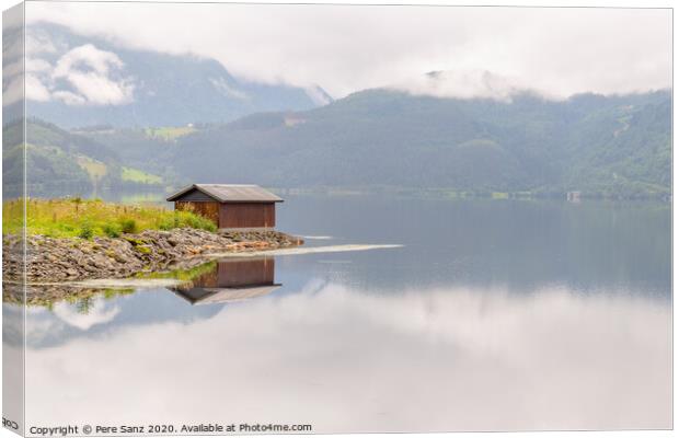 Wooden cabin in the shore of a fjord in Vorway Canvas Print by Pere Sanz